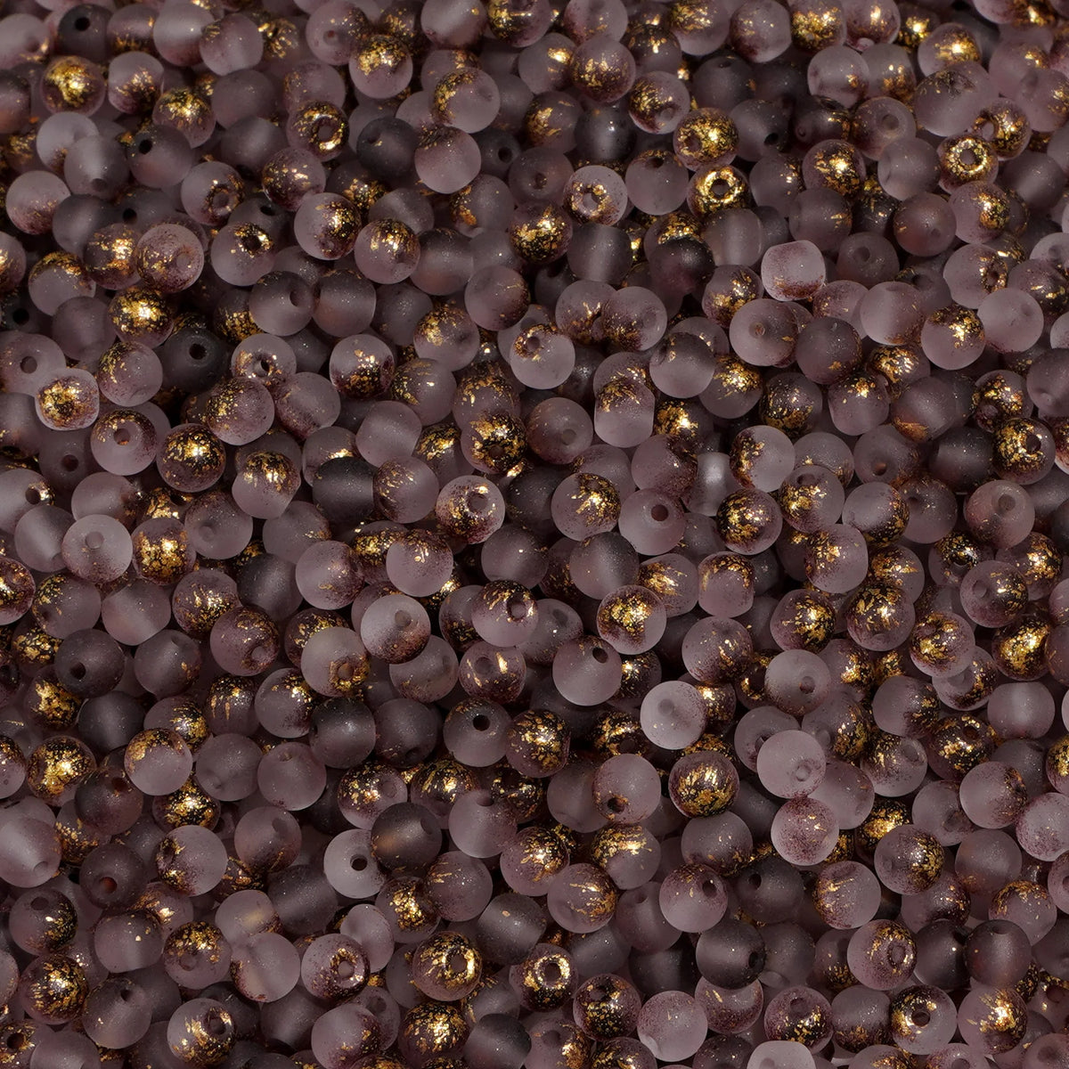 Set of 100 gold-splashed 4mm glass rice beads from Corporación Turística, ideal for jewelry making and craft projects.
