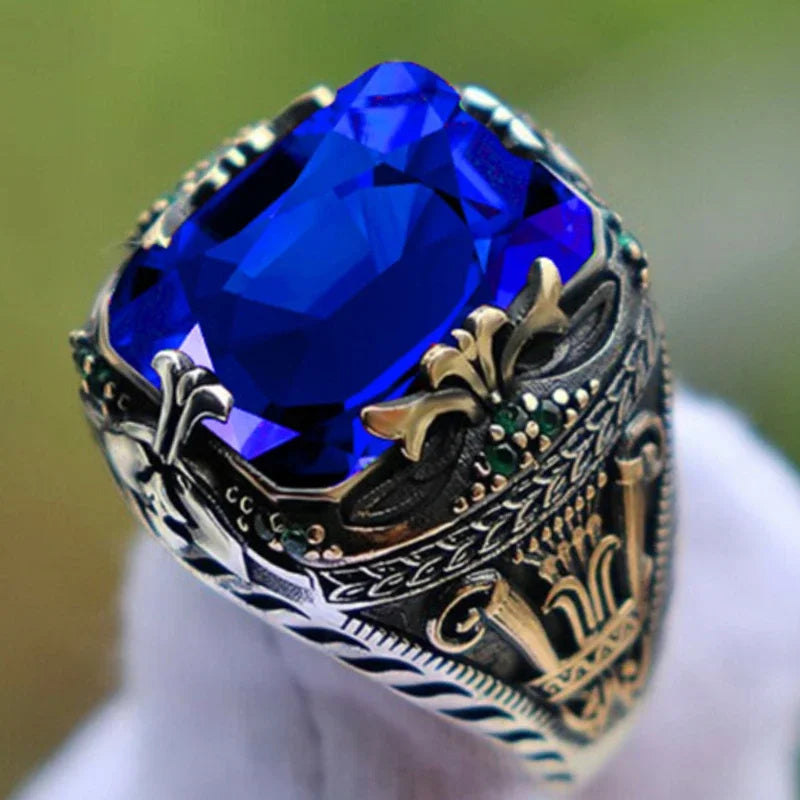 Luxury emerald ring with intricate inlay design, featuring gemstones, crafted by Corporación Turística.