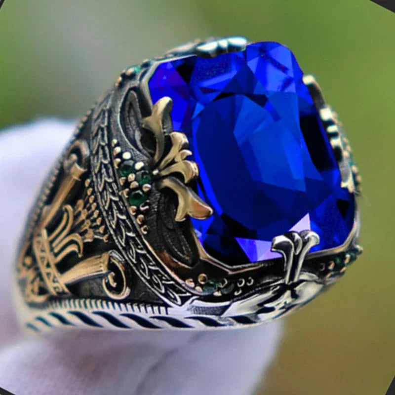 Luxury emerald ring with intricate gemstone inlays, designed for the shoulder, by Corporación Turística.