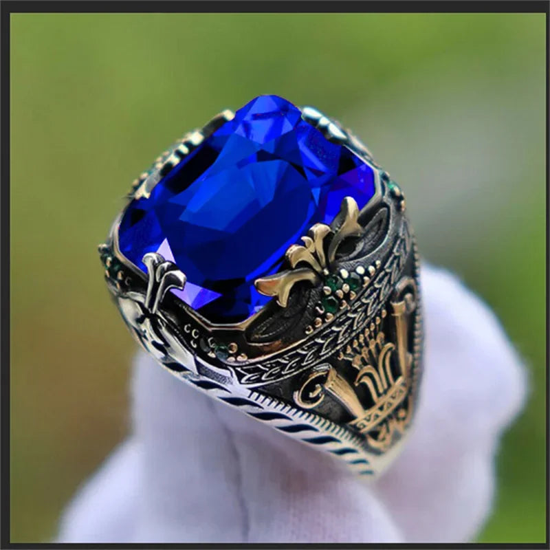 Luxury emerald ring with intricate gemstone inlays, designed for the shoulder, by Corporación Turística.