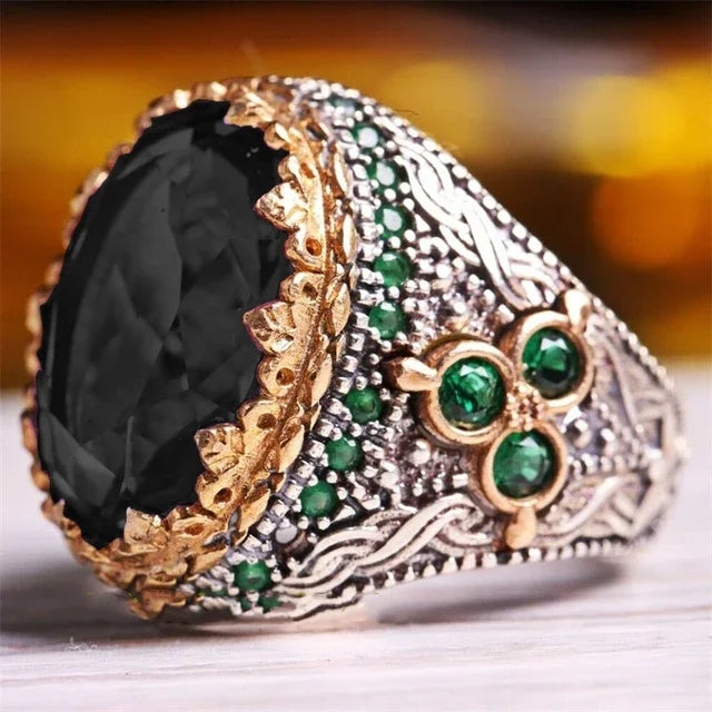 Luxury emerald ring with intricate gemstone accents, featuring a bold design for the shoulder area, by Corporación Turística.