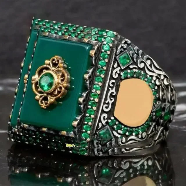 Luxury emerald ring with intricate gemstone inlays, designed for the shoulder, by Corporación Turística.