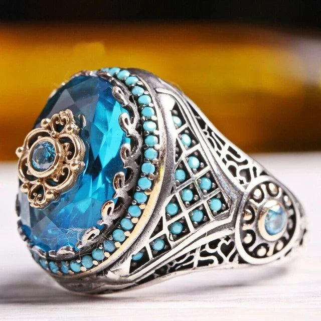 Luxury emerald ring with intricate gemstone inlays, designed for the shoulder, by Corporación Turística.