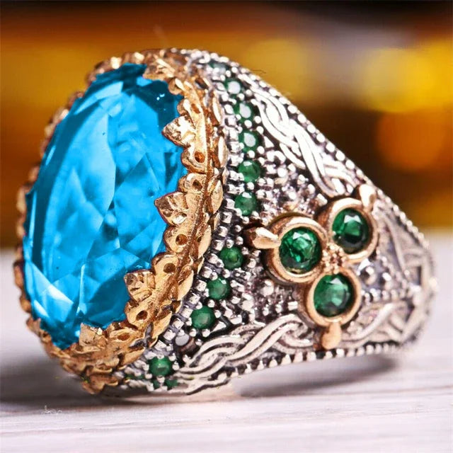 Luxury emerald ring with diamond inlays, featuring intricate design and gold band, designed for special occasions.