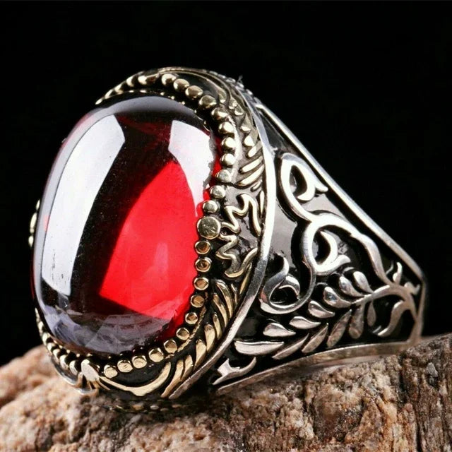 Luxury emerald ring with intricate inlay designs, showcasing vibrant green gemstone and detailed craftsmanship.