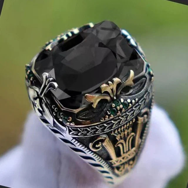 Luxury emerald ring with gemstone inlays, featuring intricate design, perfect for elegant jewelry collection.