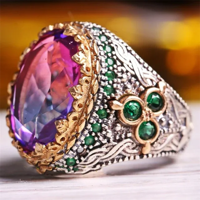 Luxury emerald ring with intricate gemstone inlays, designed for shoulder adornment, by Corporación Turística.