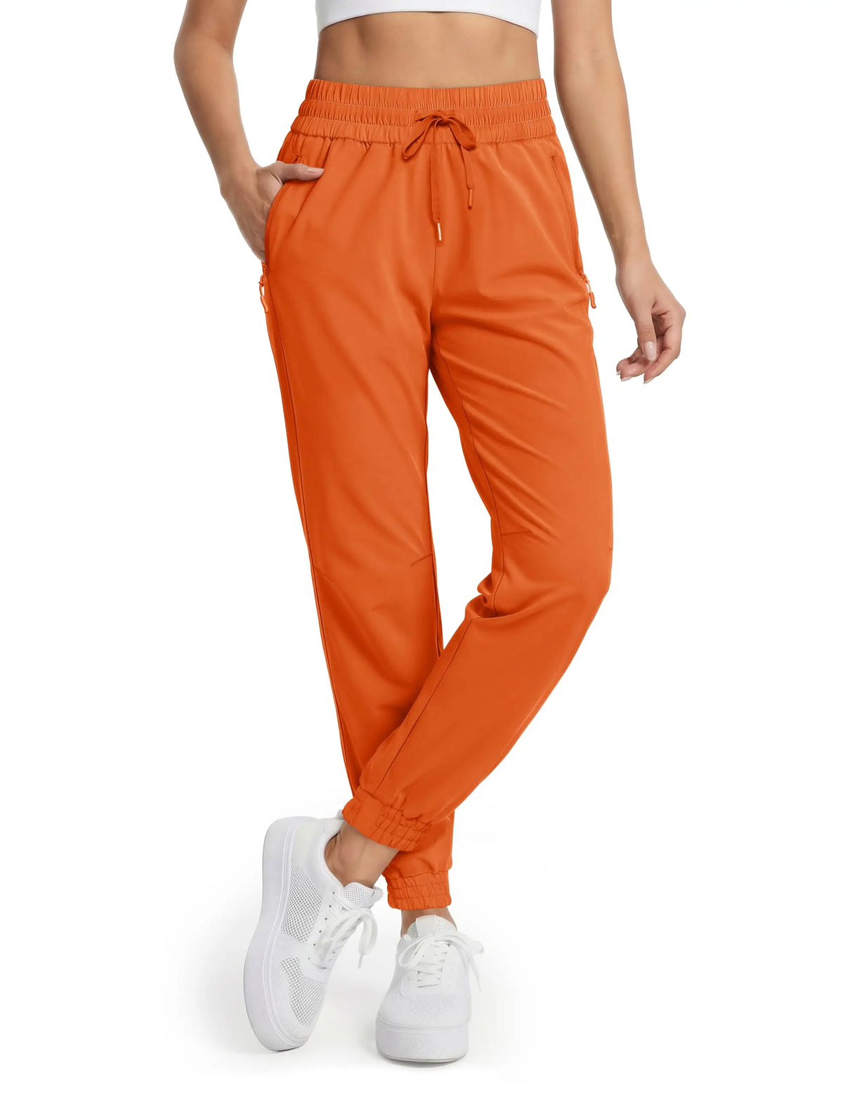 Magcomsen waterproof hiking pants for women in vibrant tomato red, designed for outdoor adventure and durability.