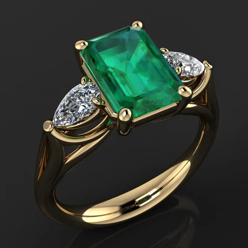 14k gold emerald ring for women featuring a vibrant green emerald gemstone and intricate jewelry design.