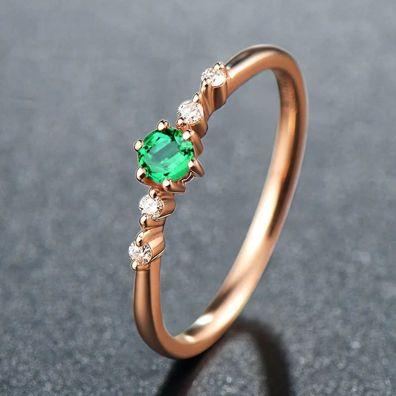 Set of natural emerald and rose gold rings for women featuring band designs, showcasing elegant jewelry by Corporación Turística.