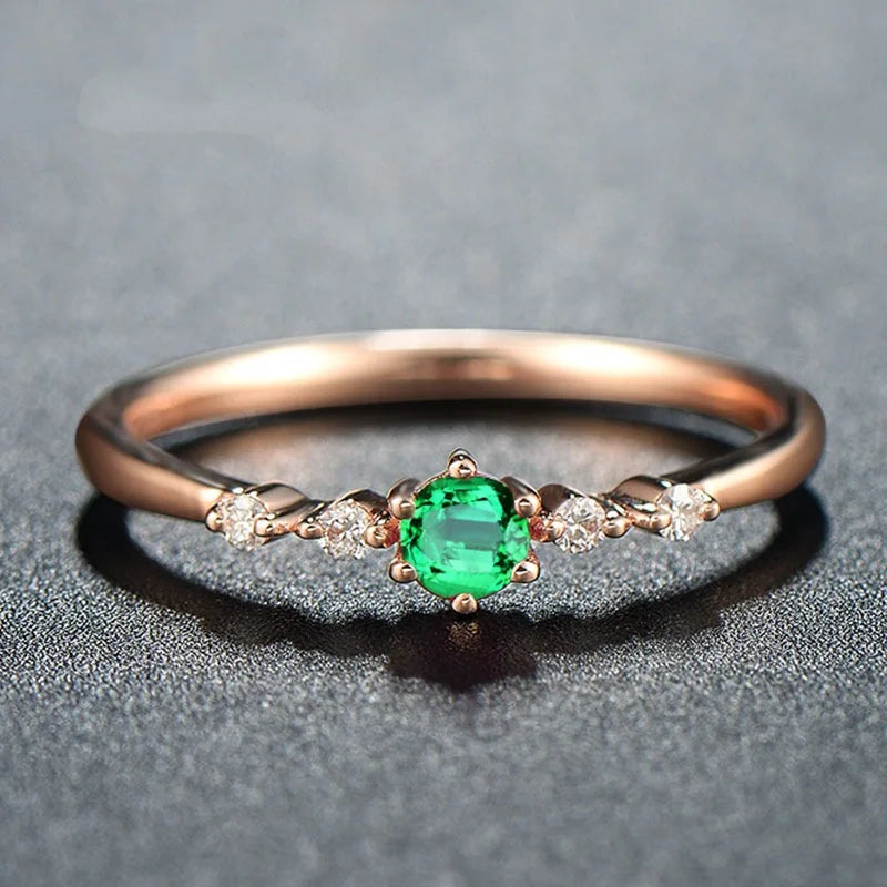 Rose gold and natural emerald ring set for women, featuring multiple bands with vibrant green stones and elegant design.