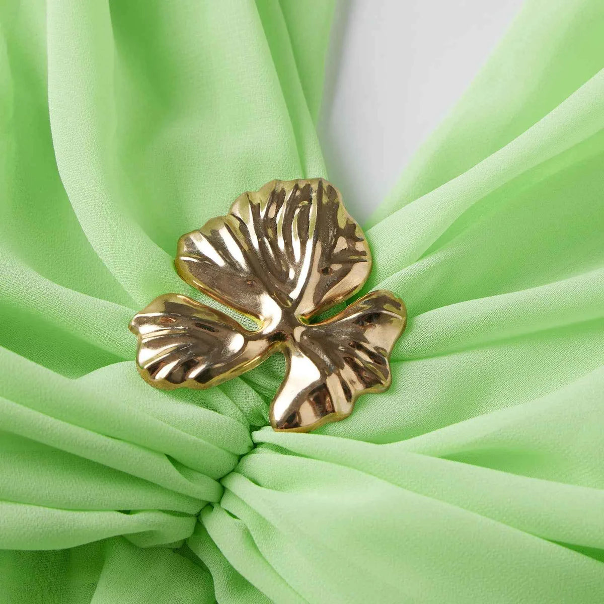 Green sleeveless halter dress for women with metallic detail, by Corporación Turística, stylish and elegant for summer occasions.