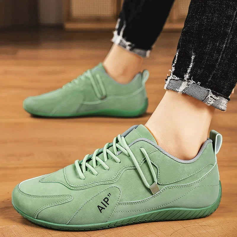 Black men's high-top moccasins and casual sports shoes by Corporación Turística, showing the stylish slip-on design and textured sole.