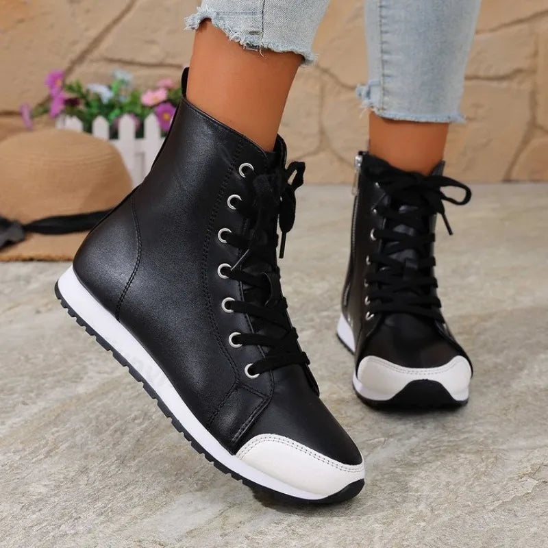 White spring and autumn women's ankle boots and sneakers from Corporación Turística, showing the side view and laces.