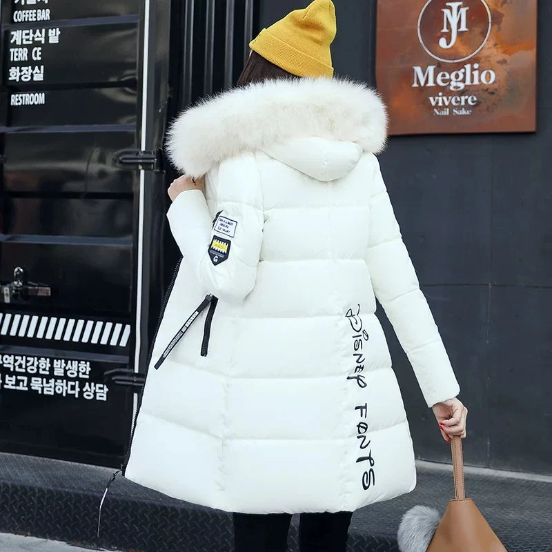 White women's winter parka coat with faux fur collar by Corporación Turística, stylish outdoor winter outerwear.
