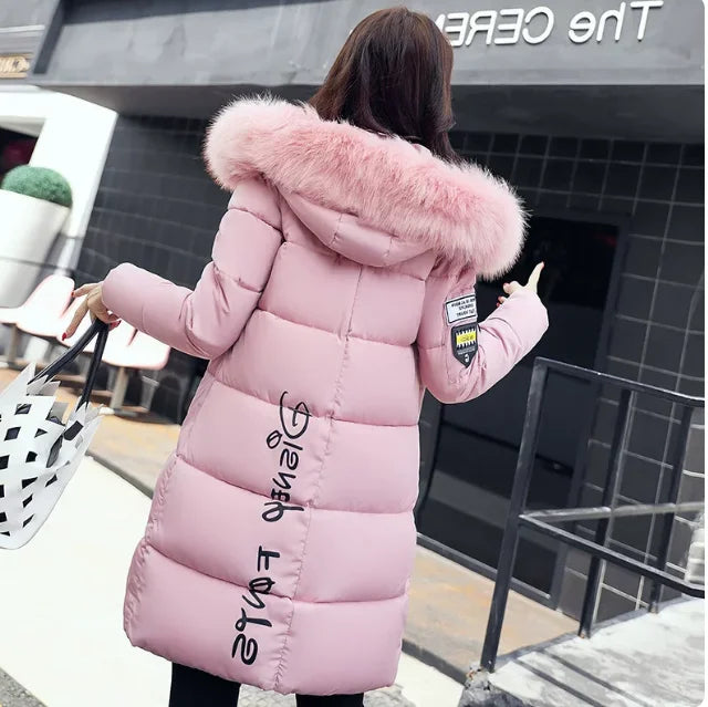 Warm women's winter parka by Corporación Turística with faux fur collar, white color, designed for cold weather comfort.