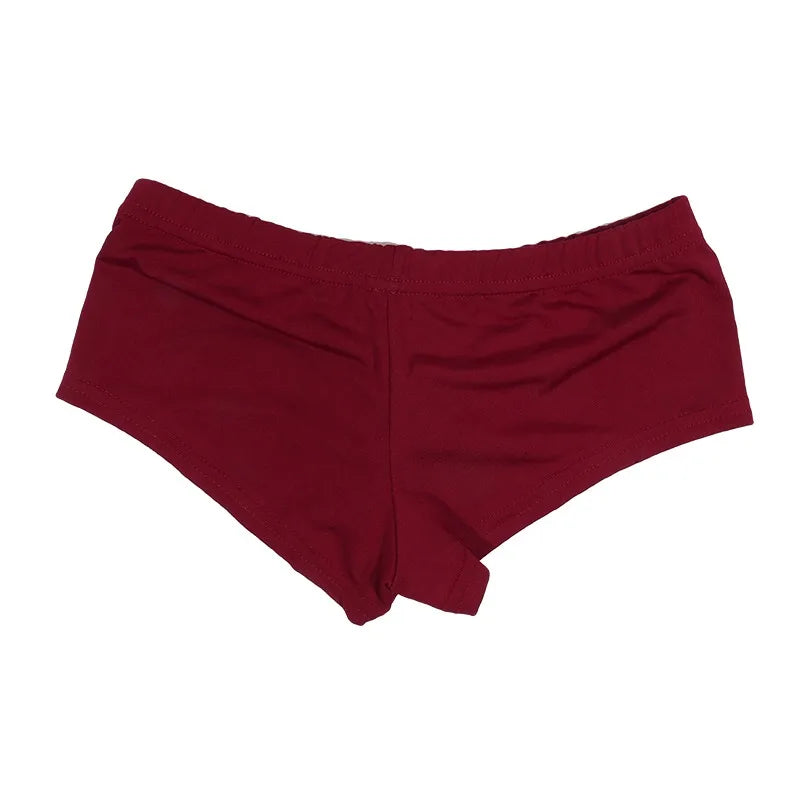 White high-waisted athletic shorts for women by Corporación Turística, shown on a model in a casual sports setting.