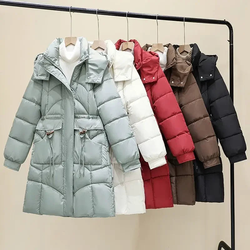 White women's hooded parka coat by Corporación Turística, medium-length winter jacket with a cozy hood and warm insulation.