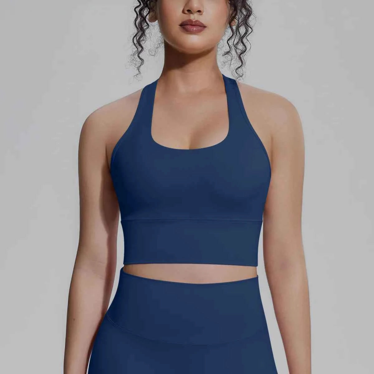 White women's sports top from Corporación Turística, designed for fitness, running, and training activities.
