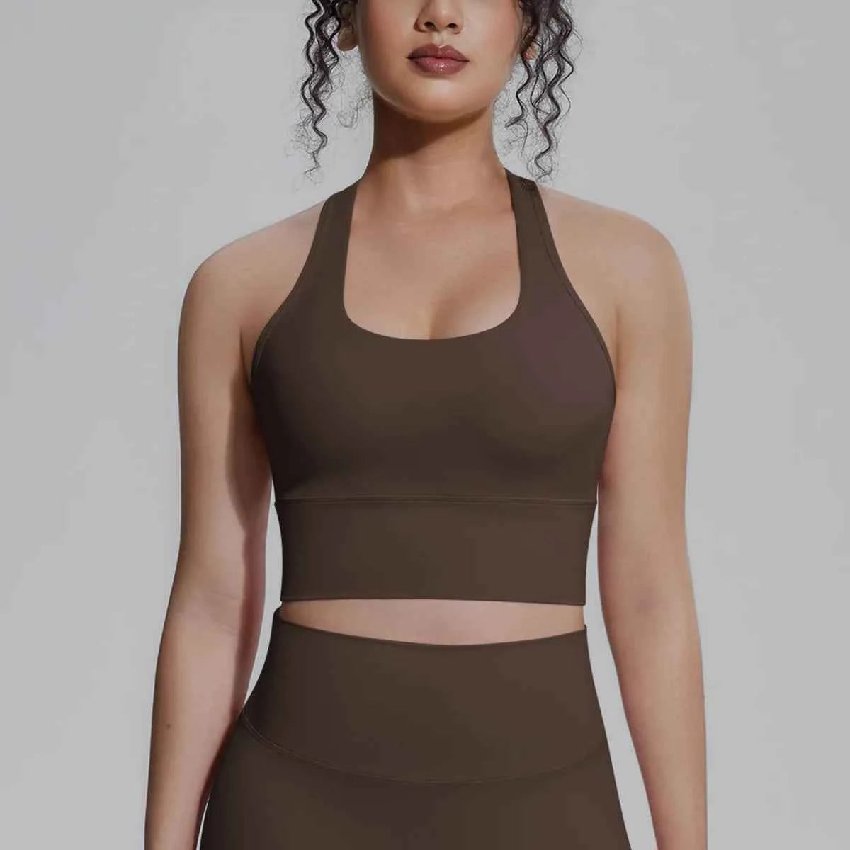 White women's sports top from Corporación Turística, designed for fitness, running, and training activities.