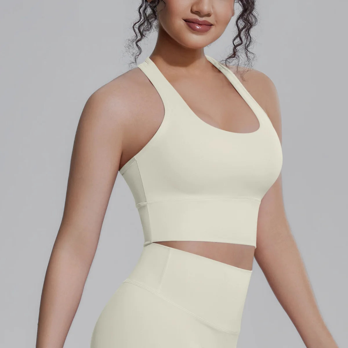 White women's sports top by Corporación Turística, designed for fitness and running, shown on a mannequin.