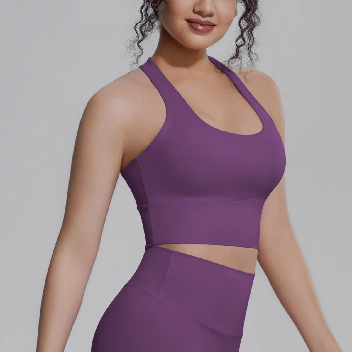 White women's sports top by Corporación Turística, designed for fitness and running, shown on a mannequin.