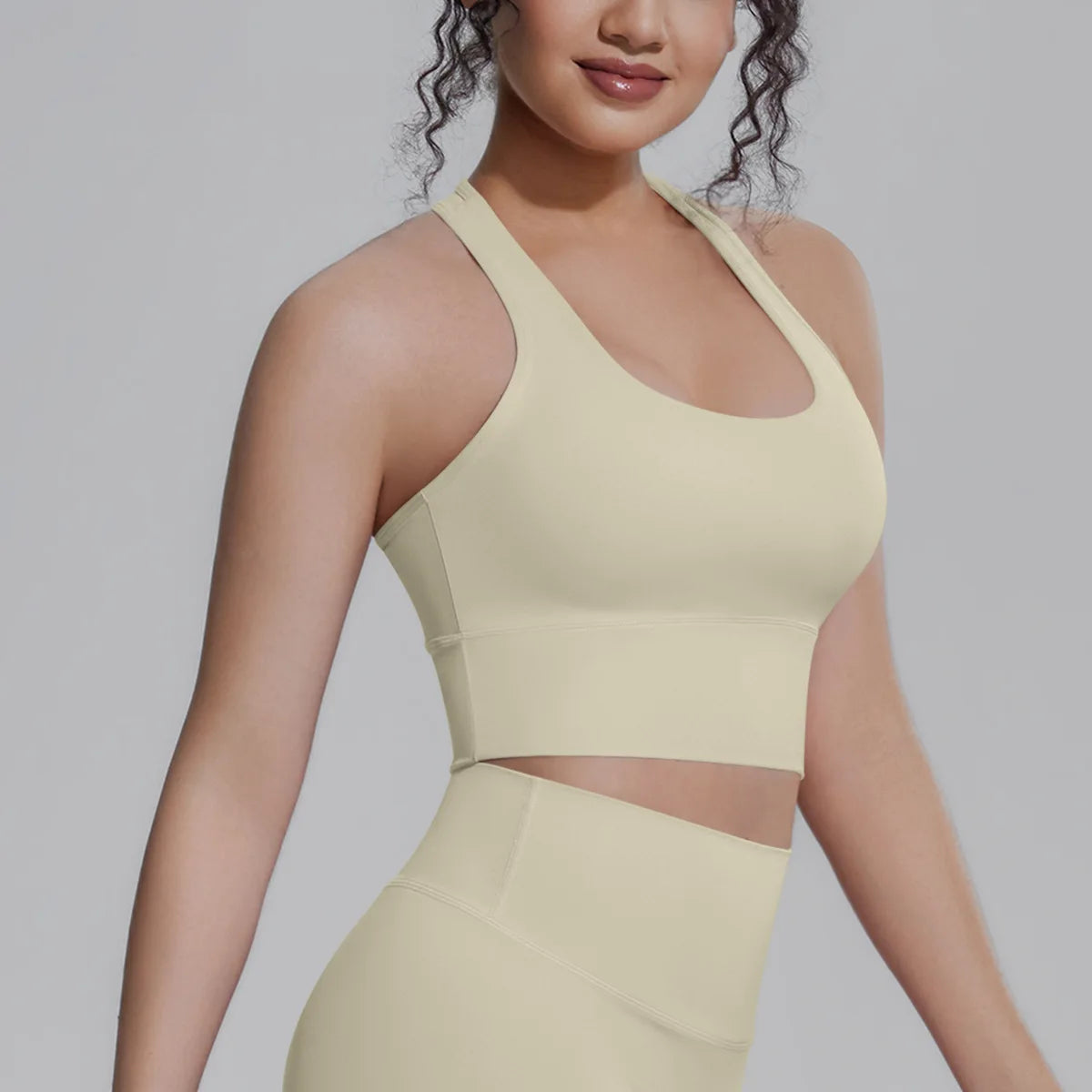 White women's sports top from Corporación Turística, designed for fitness, running, and training activities.