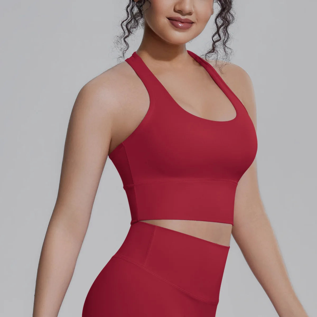 White women's sports top by Corporación Turística, ideal for fitness, running, and training activities.