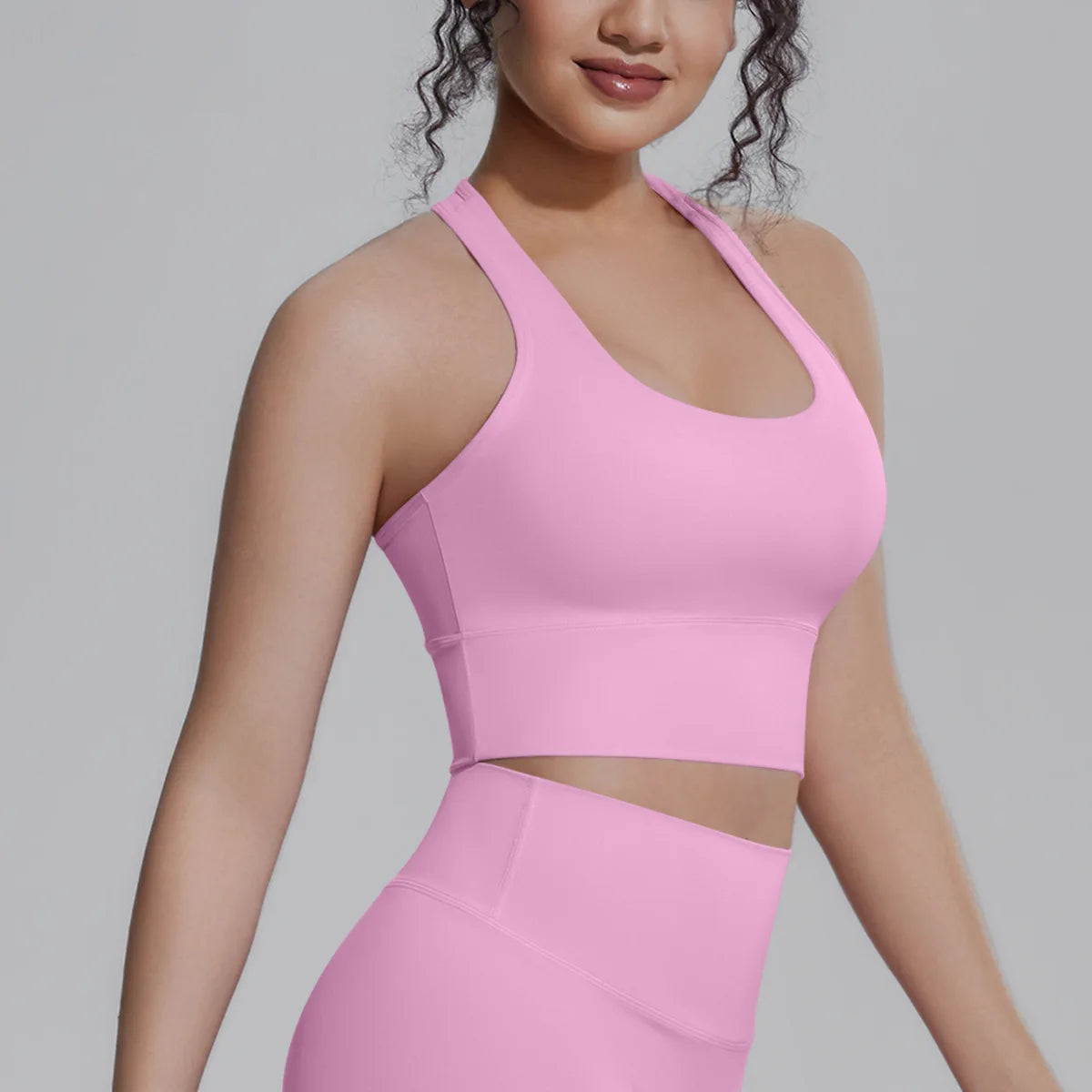 White women's sports top for fitness and running by Corporación Turística, shown on a model with a fitted design and breathable fabric.