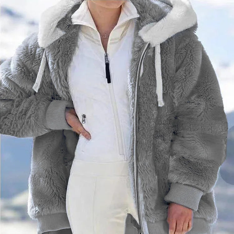 White women's oversized fleece zip-up coat by Corporación Turística, showing the relaxed fit and cozy fabric.