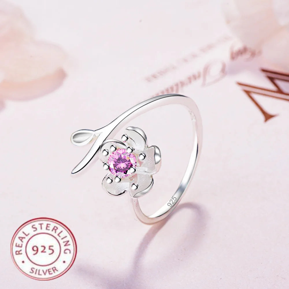 Sterling silver 925 ring with floral design and high-quality cubic zirconia, showcasing detailed flower motifs and sparkling stones.