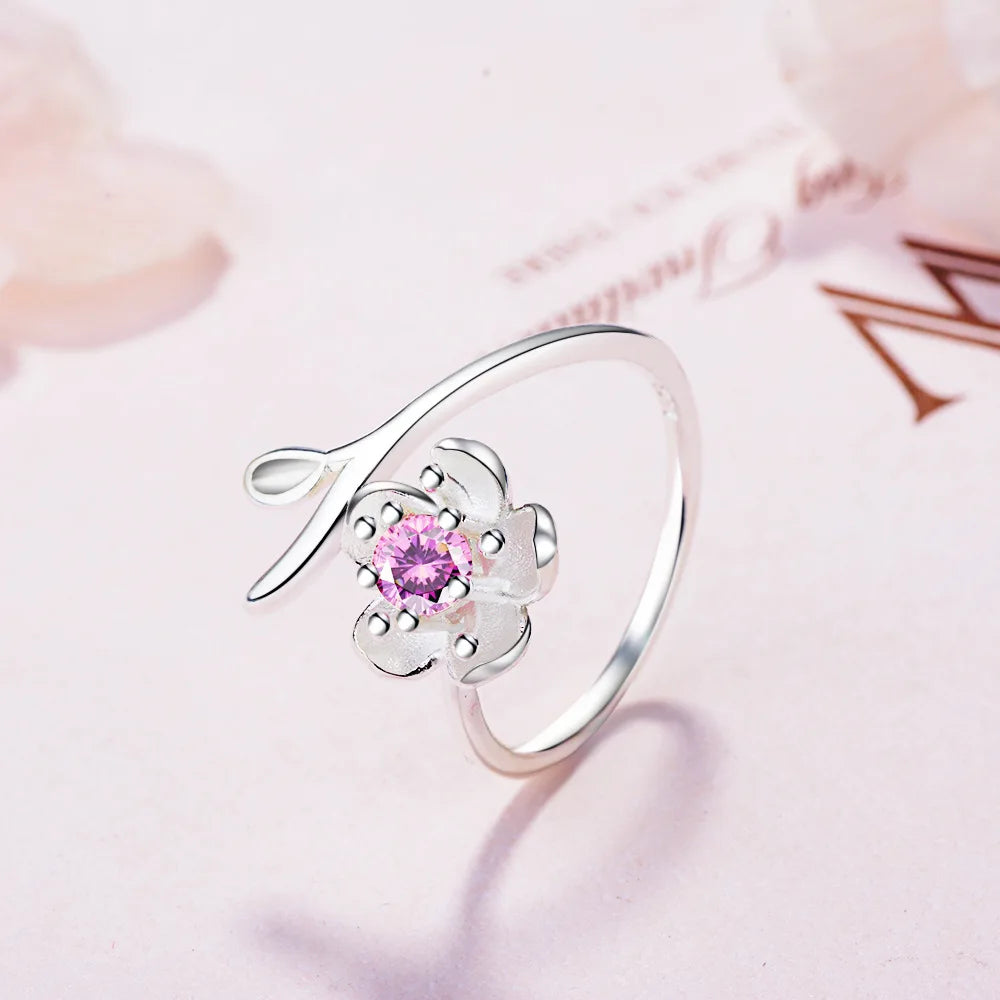 Sterling silver 925 ring with floral design and high-quality cubic zirconia, showcasing intricate flower details and sparkling gemstones.
