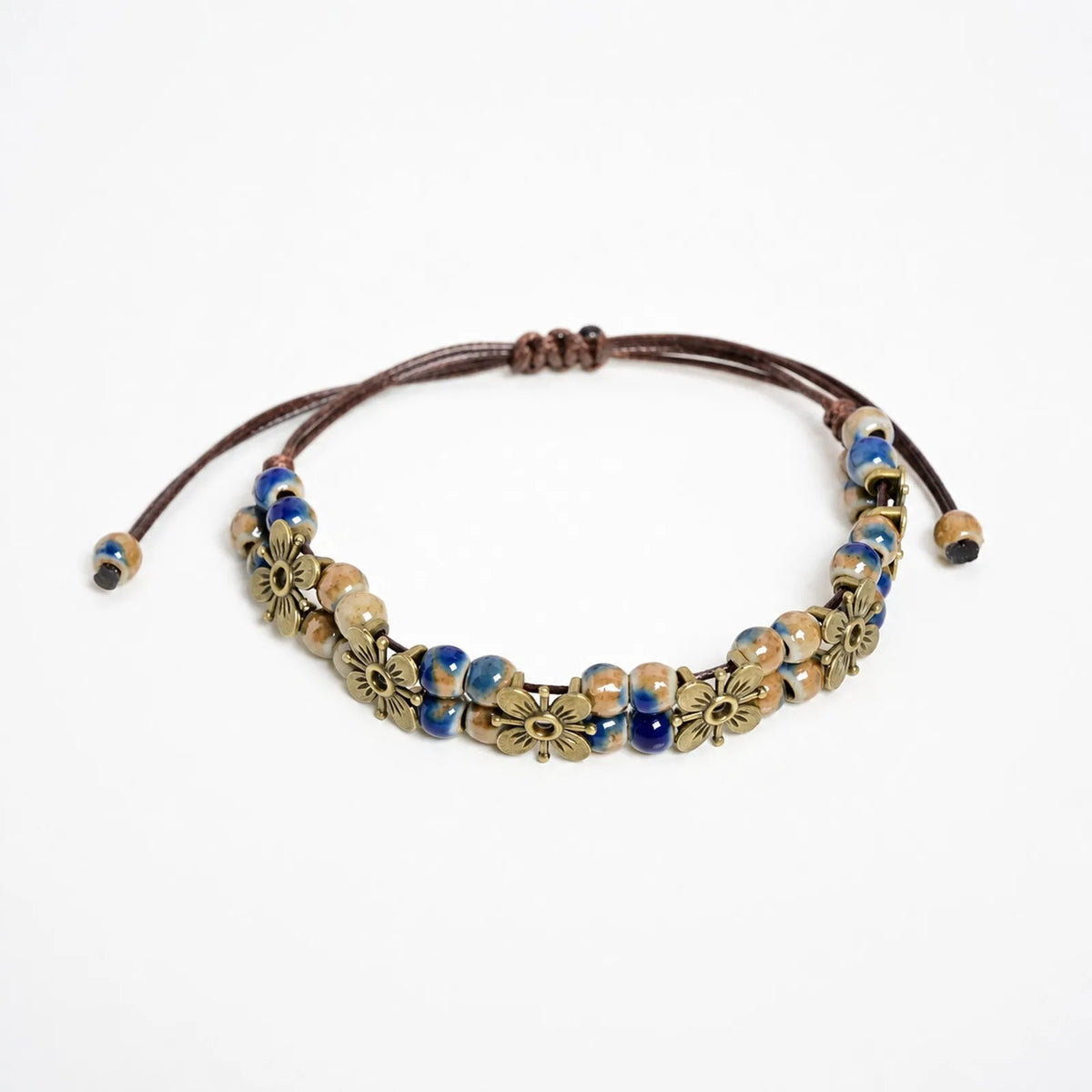 Handmade ceramic bead chain bracelet with intricate details, featuring a stylish design and natural tones, by Corporación Turística.