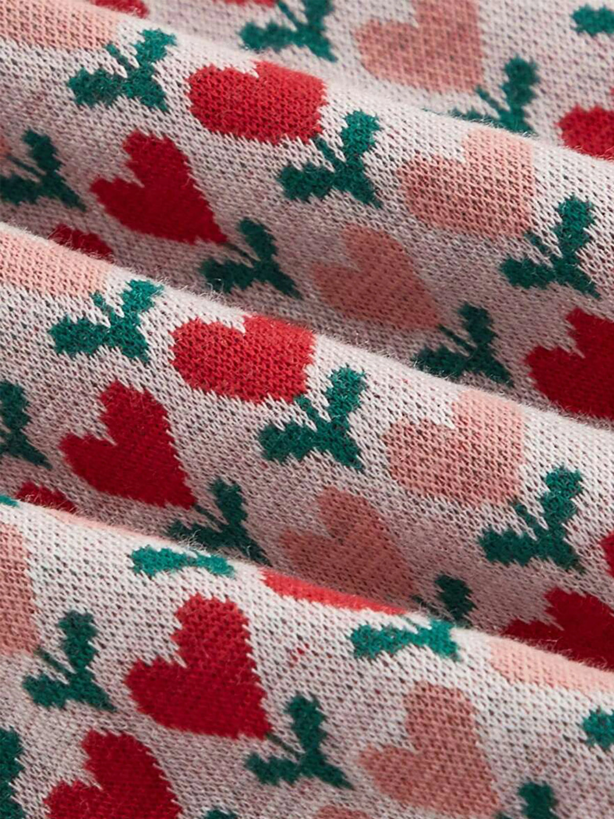 Elegant sleeveless knitted dress with lapel collar by Corporación Turística, shown in a close-up image highlighting the fabric and design.