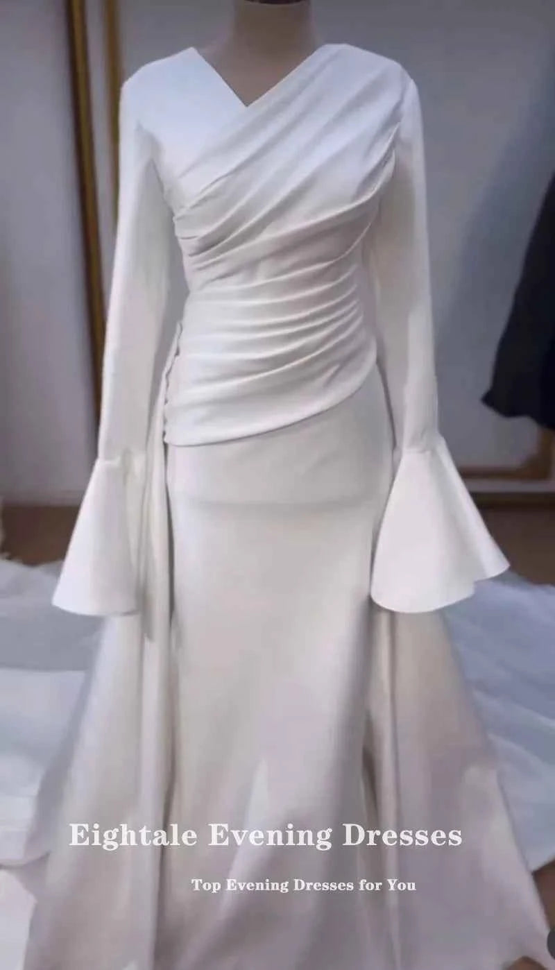 Elegant ivory Arab bridal dress by Eightale featuring a mermaid silhouette, V-neckline, and long sleeves.