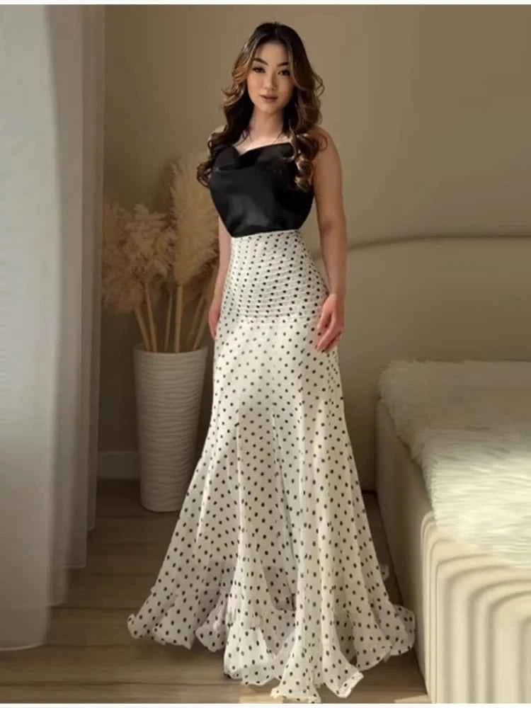 Elegant white maxi mermaid skirt with polka dots and ruffles, perfect for a sophisticated summer look by HOLD YOUNG.