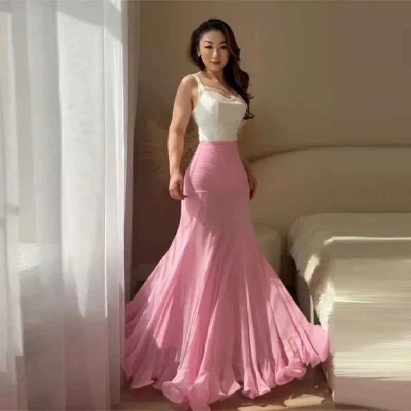 Elegant white polka dot maxi mermaid skirt with ruffles by HOLD YOUNG, perfect for a sophisticated summer look.