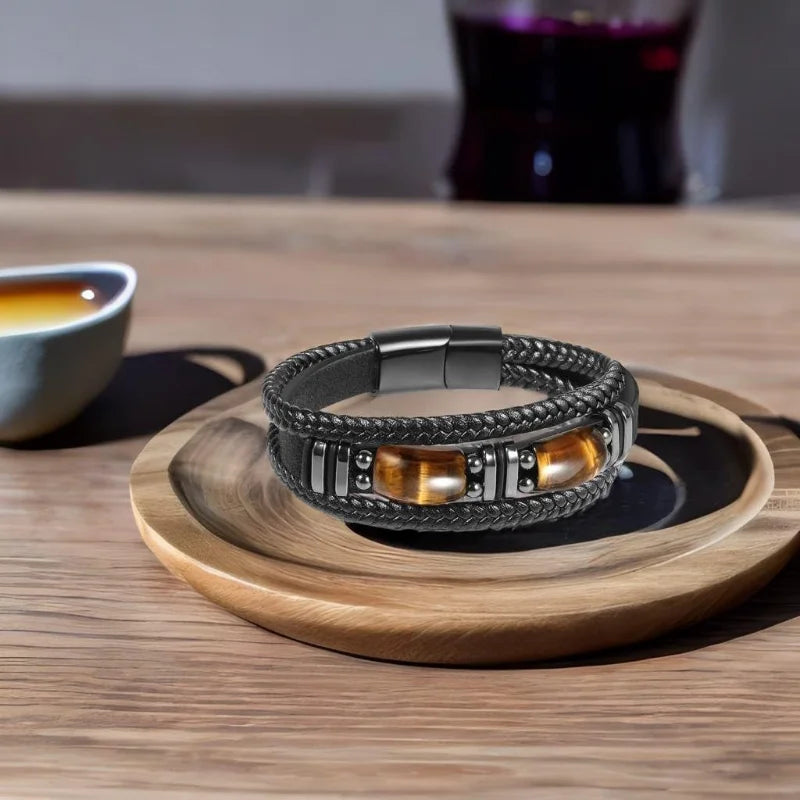 Black leather men's bracelet with tiger eye stone, stylish and protective, by RUIYI, featuring a 19cm (7.5 inch) adjustable fit.